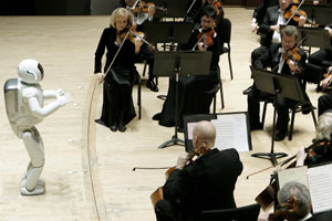 Honda's ASIMO robot conducts the Detroit Symphony Orchestra during a program in Detroit, Tuesday, May 13, 2008. ASIMO will conduct Mitch Leigh's