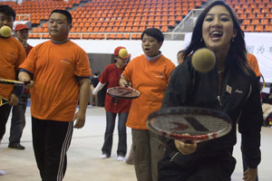 Michelle Kwan tries to bounce a ball with participants in an Special Olympics Sports Day event in Beijing, China, Sunday, Jan. 21, 2007. (AP Photo/Ng Han Guan)