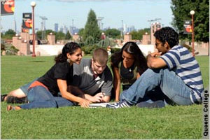 Four Students Sitting on Grass (Photo: Queens College)
